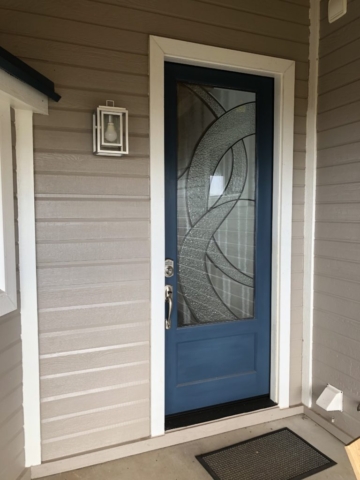 a blue front door with glass window inset