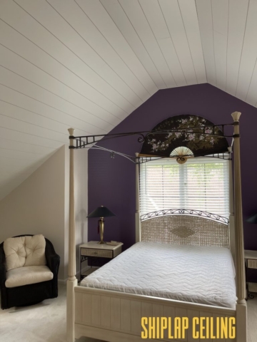 a bedroom with canopy bed and shiplap raised ceiling