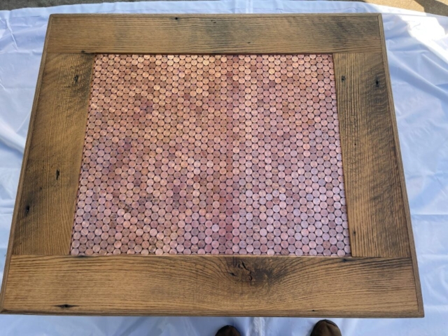 a table top made from wood and pennies